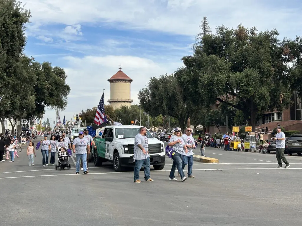 Comcast employees march in the 106th Central Valley Veterans Day Parade in Fresno, Calif. on November 11, 2025.