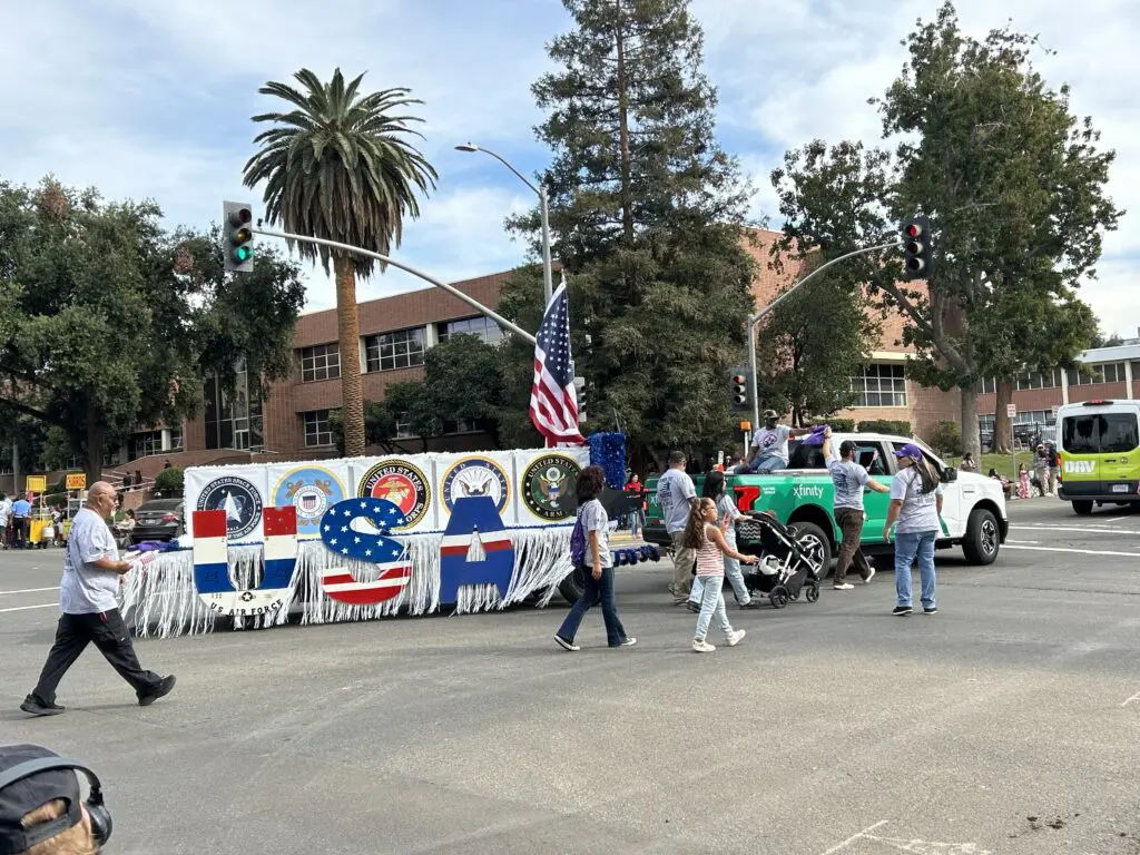 Comcast employees march in the 106th Central Valley Veterans Day Parade in Fresno, Calif. on November 11, 2025.