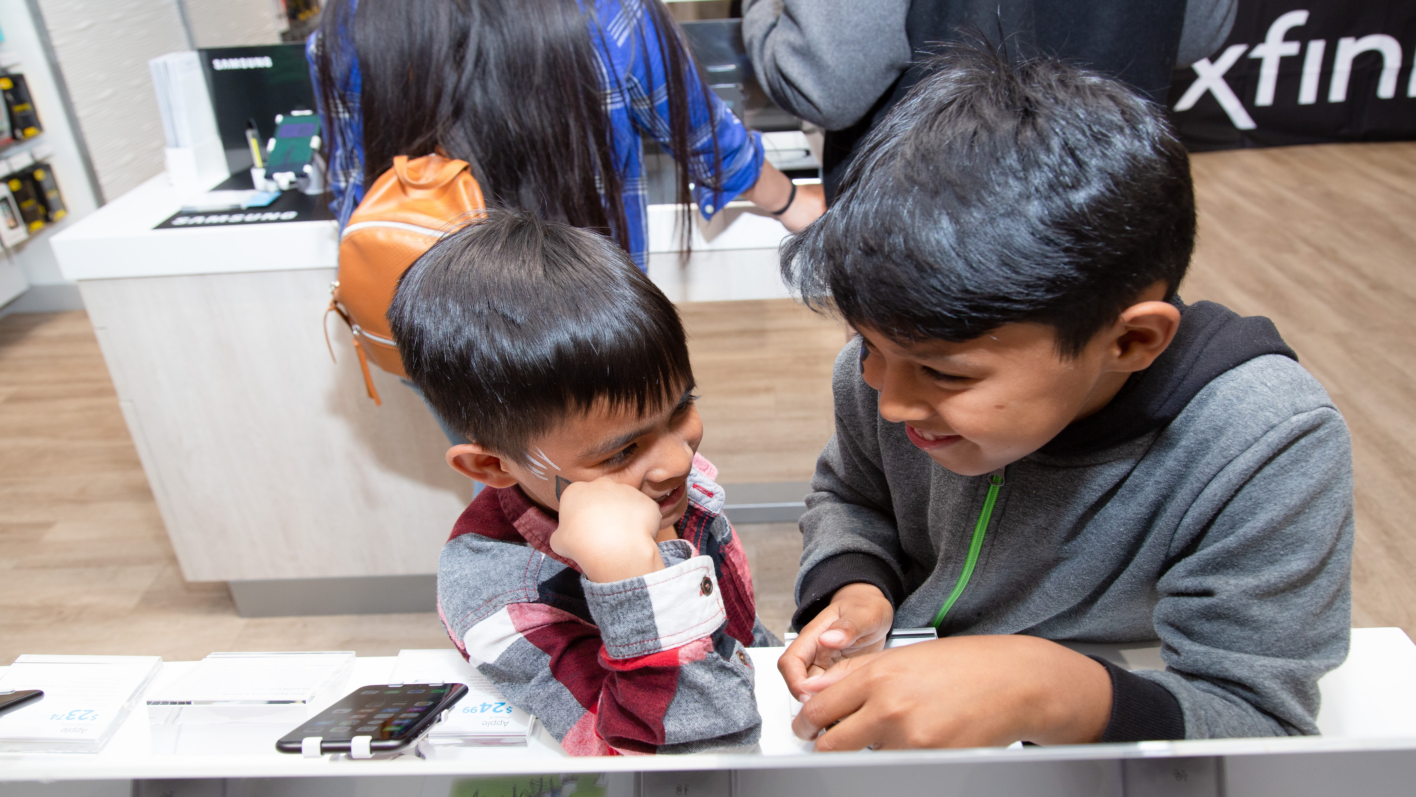 two young boys in an xfinity store