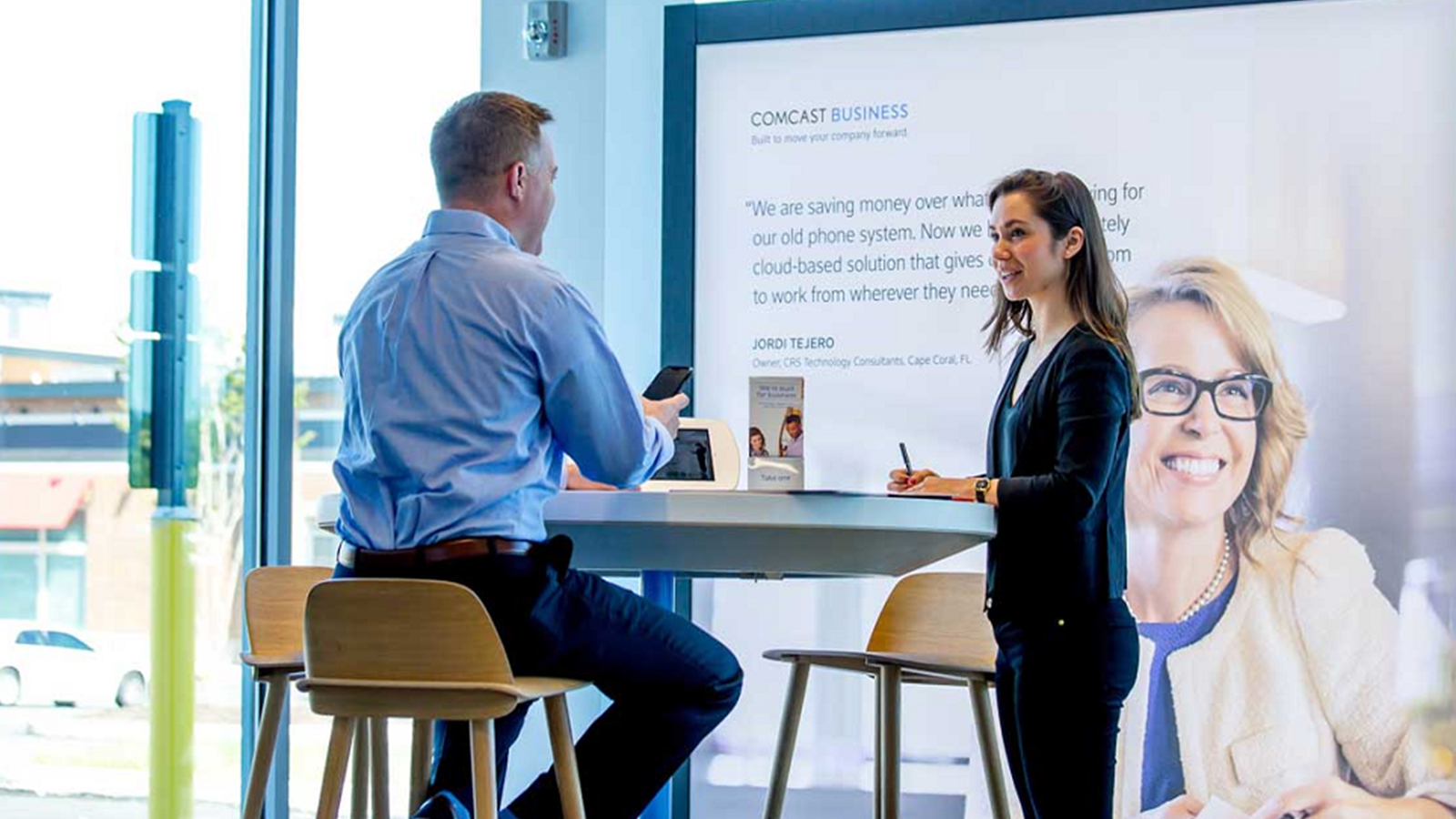 Male and Female having a conversation at an Xfinity Store.