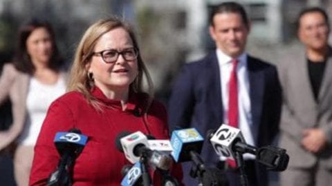 A woman speaking at a podium.