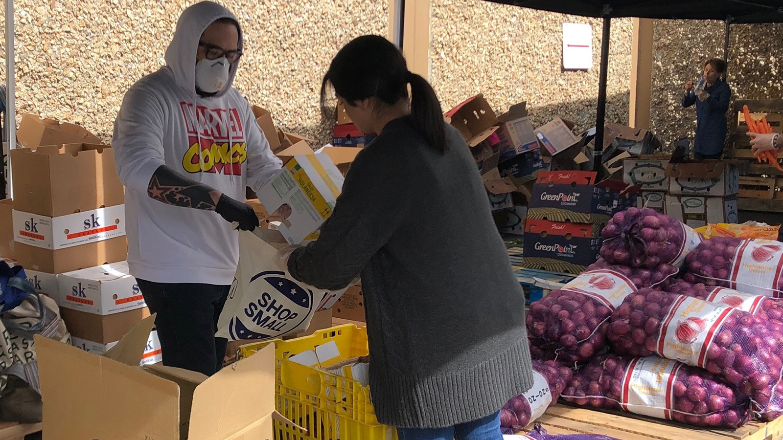 Male and Female packing food at the Canal Food Bank.