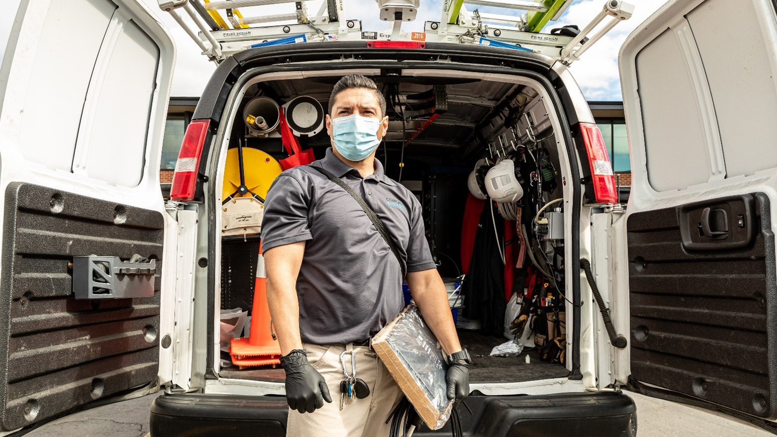 An employee standing in front of an Xfinity truck.