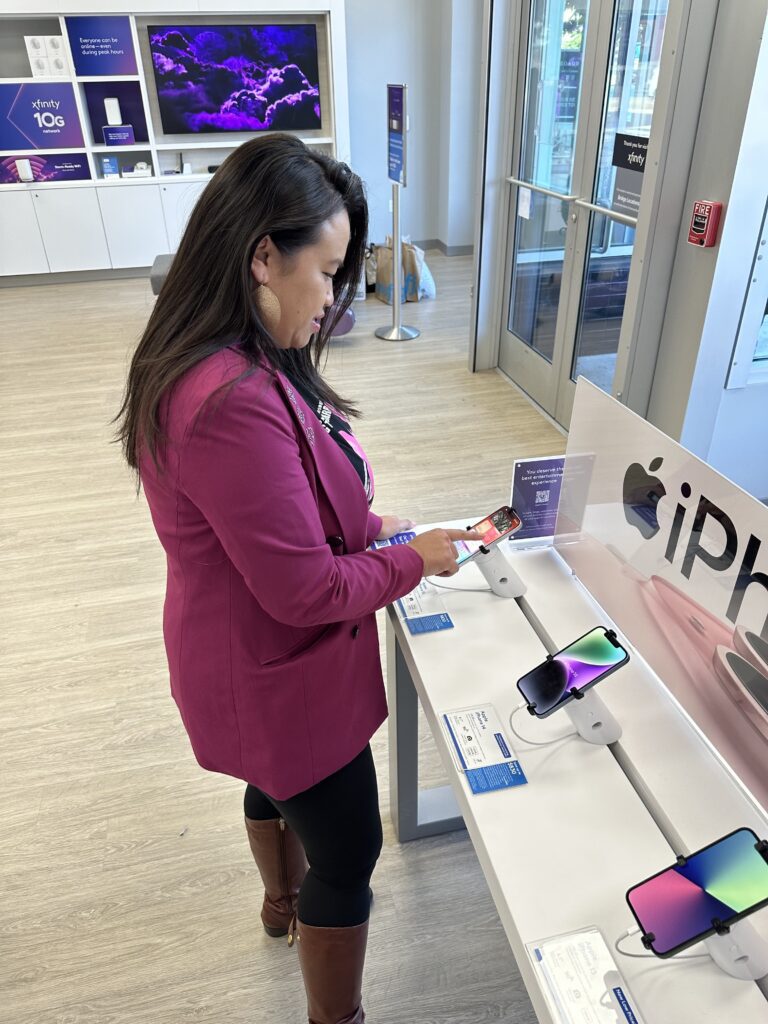 Oakland Mayor Sheng Thao explores the new iPhone 15 at the Xfinity store on Broadway in Oakland, CA