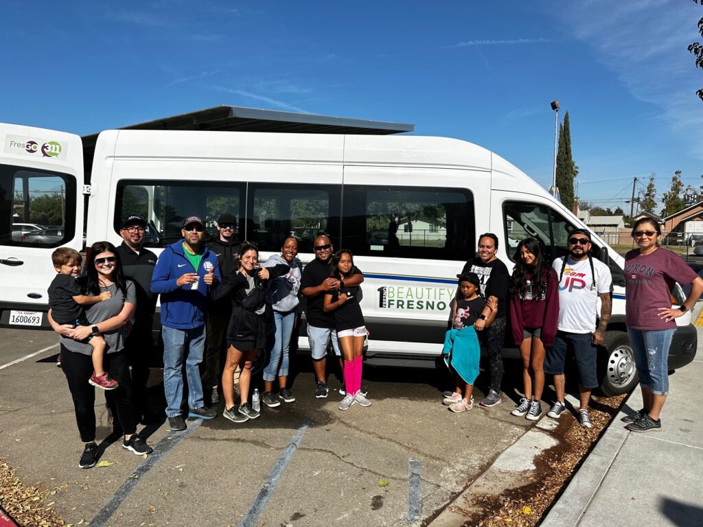 Comcast California team stands in front of white Beautify Fresno van