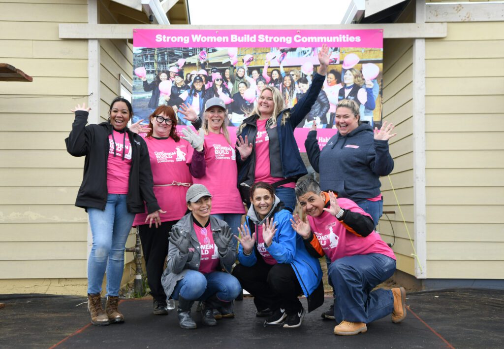 Comcast volunteers for Habitat for Humanity's Women Build help build a home during a Team UP event on Friday, March 1, 2023 in Sacramento, Calif.