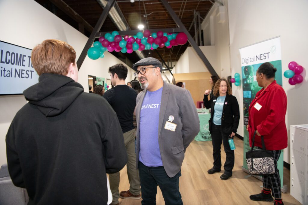 Jacob Martinez, center, founder and CEO of Digital Nest, talks with folks at the grand opening in Stockton. Digital Nest held its grand opening at its fifth location on Friday, January 24, 2025 in Stockton, CA. Comcast gave them a $200,000 check at the event. (Anne Chadwick Williams/Comcast)