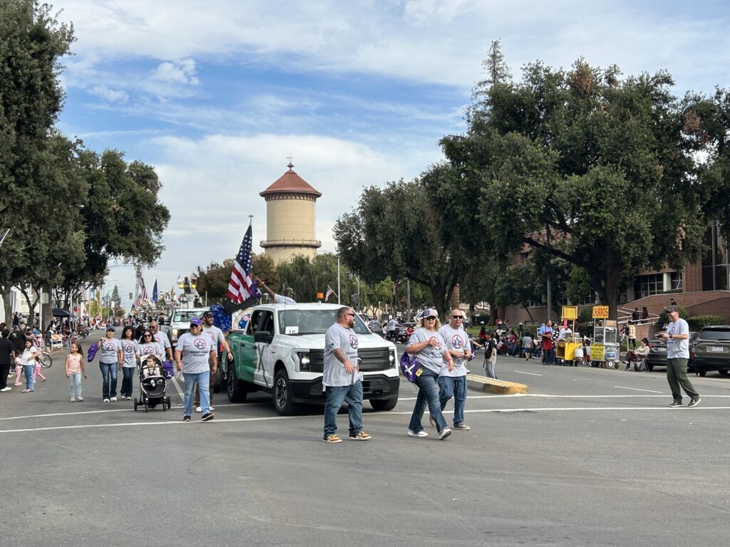 Comcast employees march in the 106th Central Valley Veterans Day Parade in Fresno, Calif. on November 11, 2025.