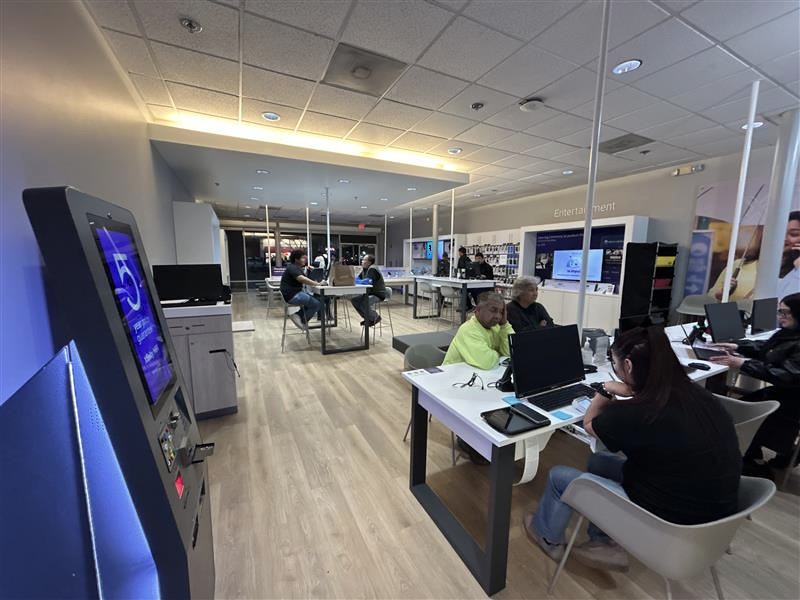 Patrons and Xfinity team members  chatting inside the South Fresno Xfinity Store.
